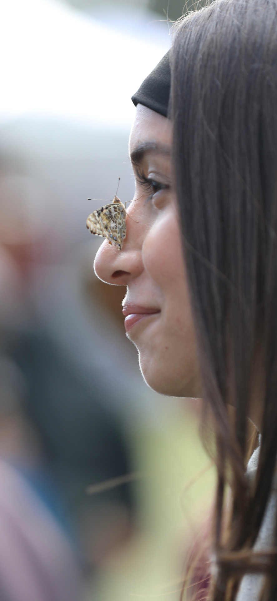 Bride with a butterfly resting on her nose